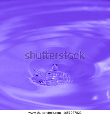 water drop bouncing on the surface of more water