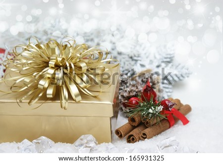 Christmas background with gift and cinammon stick nestled in ice