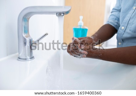 Close Up Of Boy Washing Hands With Soap At Home To Prevent Infection Royalty-Free Stock Photo #1659400360
