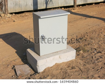 Electrical steel cabinet is attached to the concrete floor                        
