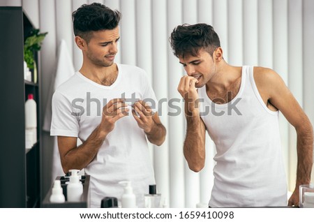 Waist up of twins standing at home in the morning stock photo