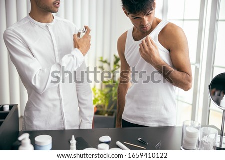 Cropped photo of two brothers standing together in room stock photo