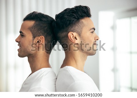 Waist up of happy brothers posing next to each other in room stock photo