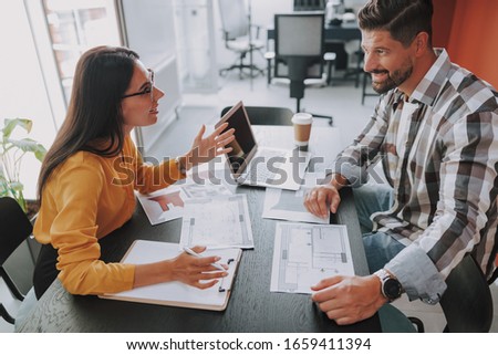 Two designers sitting in office and talking stock photo