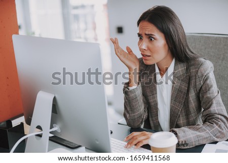Waist up of businesswoman sitting at her workplace stock photo