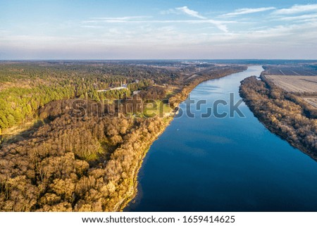 Wide big river. Autumn landscape, aerial view. Evening shooting at sunset.