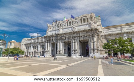 Front view of Milan antique central railway station timelapse . Blue cloudy sky at summer day. The station was inaugurated in 1931. Royalty-Free Stock Photo #1659500512