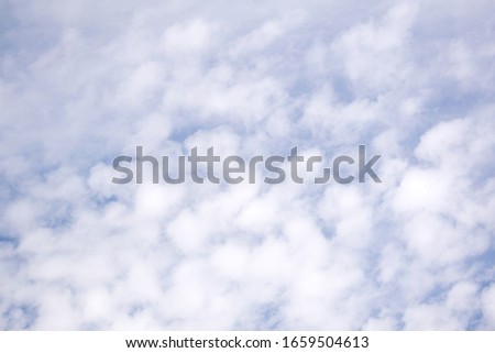 Blue sky background with tiny clouds. Beautiful clouds on blue sky