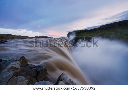 A picture of the Majestic Dettifoss during blue hour, purple sky, Iceland. The picture was taken close to midnight in july.