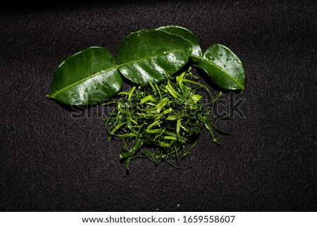 Shredded kaffir lime leaves on black screen