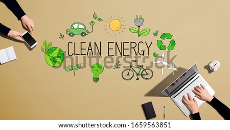 Clean energy concept with people working together with laptop and phone
