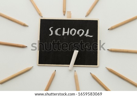 back to school concept with pencils and black board.