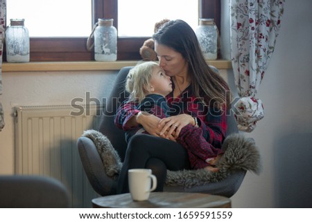 Mother and child, sitting in rocking chair, hugging