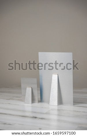 Metal print photography product with kickstand - back view. Shot on isolated white and gray background with blank empty room space for text or copy.