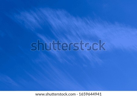 Blurry image of cloudy sky. Blue sky and white clouds. Colorful nature background.
