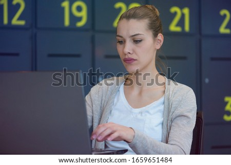 Young female business woman using laptopat her work. Brainstorming business plan and prepairing for the meeting.