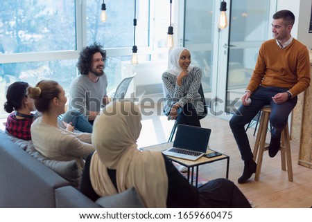 Corporate Meeting Room. Confident and Handsom Executive Director Decisively  Delivers Report to a Board of Executives about Company’s Record Breaking Revenue. Multiethnic business corporate concept.