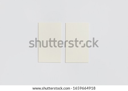 Two vertical Business Cards Mock-up at white textured paper background.High resolution photo.Top view