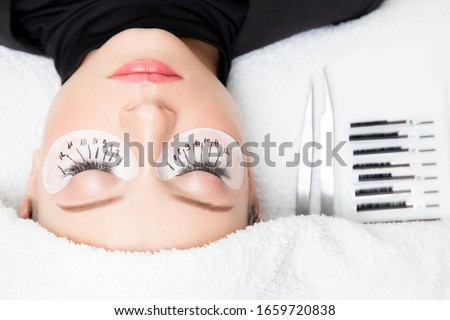Macro photo woman with long lashes in beauty salon. Concept eyelash extension procedure.