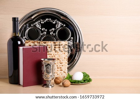 Symbolic Pesach (Passover Seder) items on wooden table, space for text Royalty-Free Stock Photo #1659733972