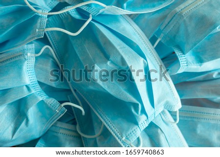 Used blue surgical protective masks. Coronavirus (COVID-19) hysteria is leading to mass mask shortages in the beginning of 2020. Royalty-Free Stock Photo #1659740863