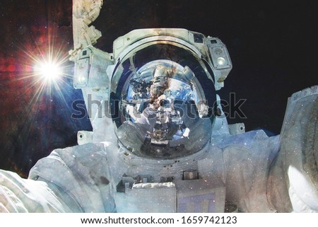 Astronaut in outer space. Science fiction art. Elements of this image furnished by NASA
