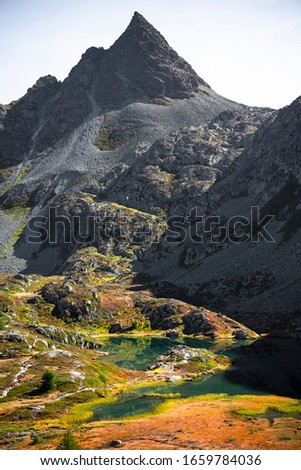 Breathtaking natural colours in a mountain landscape with a lake on a plateau on a rocky mountain .
