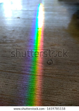 rainbow colors from lighting on a wooden table