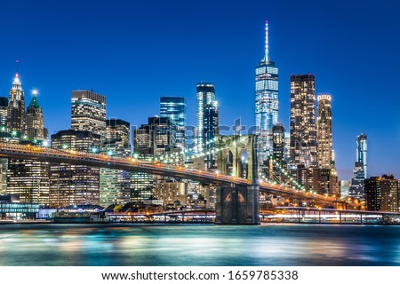 Brooklyn Bridge and Manhattan skyscrapers cityscape skyline during night, New York, USA