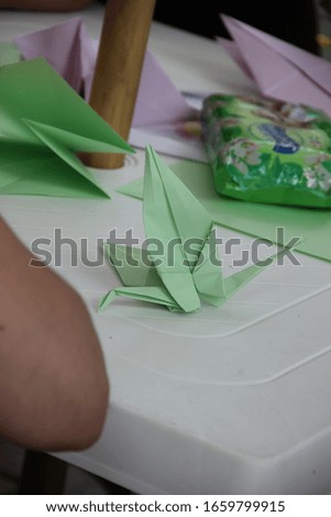 Origami paper swan in hands
