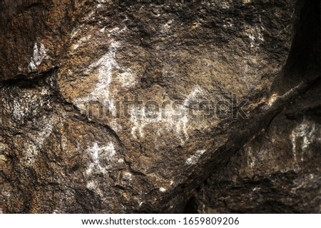 A group of hunters haunts the lama, old prehistoric rock art in Sumbay Cave from paleolithic era (6000-8000 BC), Arequipa departement, Southern Peru