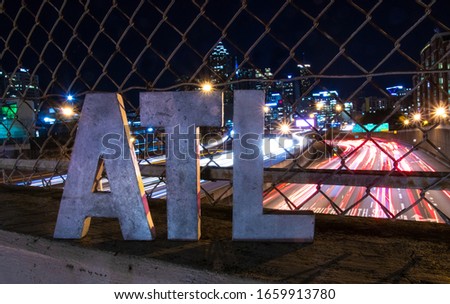 Atlanta traffic at night with ATL sign in foreground  Royalty-Free Stock Photo #1659913780