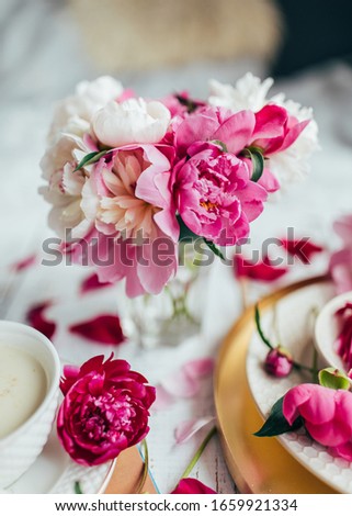 Sweet candies, drink in cup, flowers piony petals and buds