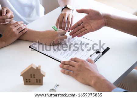 Real estate concept, Real estate agent proposes to client to sign contract, Signing the agreement form to buy a house, Moving house or renting real estate.