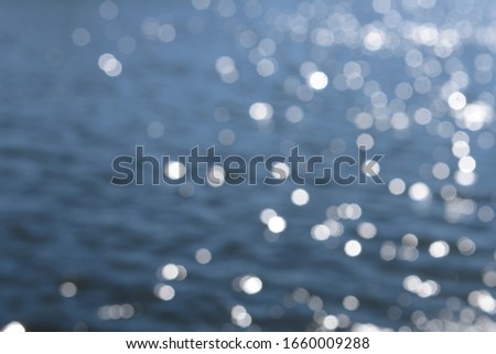 Abstract background bokeh sun light reflections on water