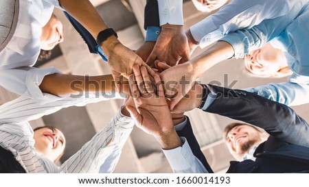 Teambuilding Concept. Coworkers Standing In Circle Holding Hands Together Celebrating Business Success In Modern Office. Panorama, Bottom View Royalty-Free Stock Photo #1660014193