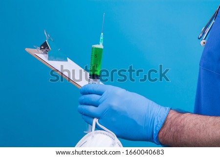 scientist holding syringe or injection, mask and reports, virus concept, vaccine and medical treatment