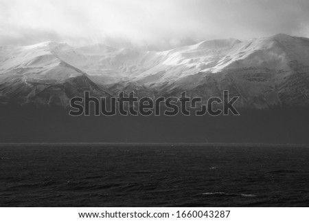 snowy mountains and ocean in balance