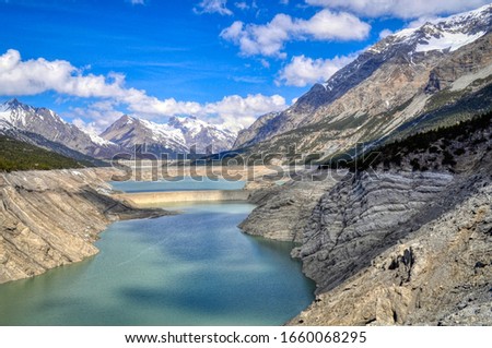 The Cancano lake and the upper San Giacomo lake, artificial water basins located in the Fraele valley at about 1900 meters above sea level in the Stelvio National Park Royalty-Free Stock Photo #1660068295