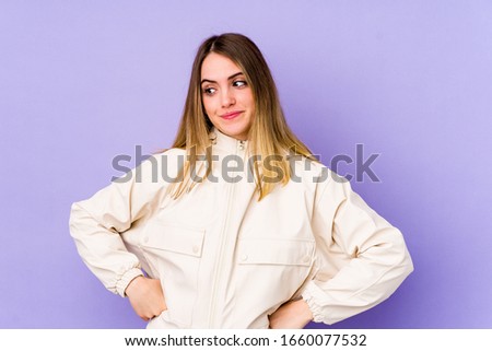 Young caucasian woman isolated on purple background dreaming of achieving goals and purposes