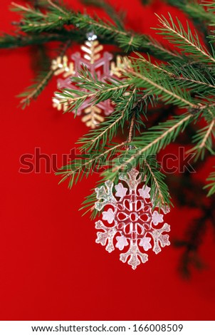 Christmas decorations in the form of snowflakes on Christmas tree branch