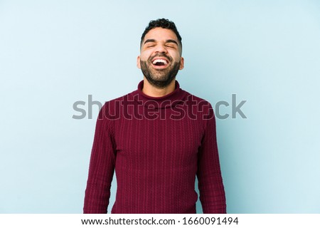 Young mixed race arabic man isolated relaxed and happy laughing, neck stretched showing teeth.