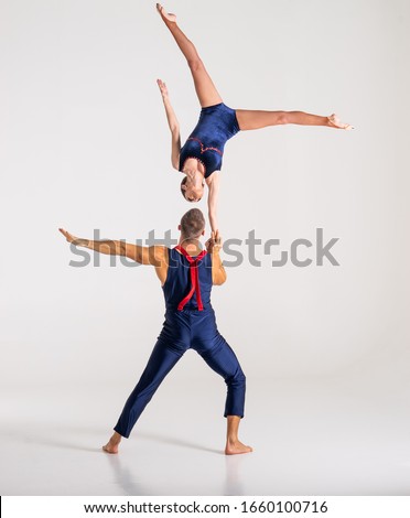 Duo Of Acrobats Showing hand to hand Trick, Isolated On White Royalty-Free Stock Photo #1660100716