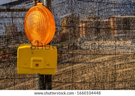 Warning light on a construction fence with copy space