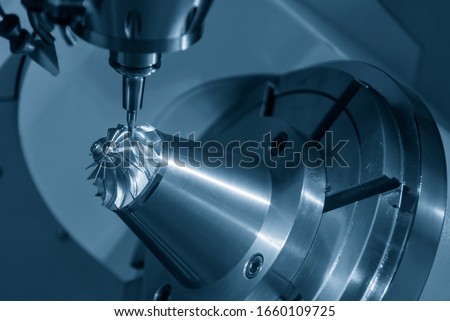 The 5-axis CNC milling machine  cutting the  aluminium  turbine propeller part by solid ball endmill tools. The turbocharger parts manufacturing process by 5-axis machining center. Royalty-Free Stock Photo #1660109725