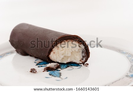A Hungarian dessert called "Túró Rudi" on a Herend porcelain plate. The inside is cottage cheese (curd) and the coating is chocolate. Royalty-Free Stock Photo #1660143601