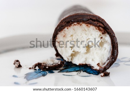 A Hungarian dessert called "Túró Rudi" on a Herend porcelain plate. The inside is cottage cheese (curd) and the coating is chocolate. Royalty-Free Stock Photo #1660143607