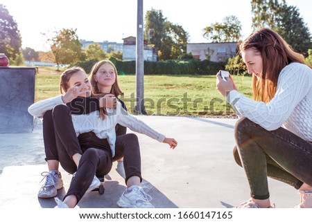 3 girls schoolgirls, selfie photo phone camera, rest after school college on weekend. In summer city, skateboarding. Emotions of happiness, fun, joy laughter, smile, entertainment. Best girl friends