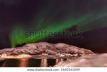 Polar lights, aurora borealis, northern lights and stars in the sky , Sommaroy,  Vesteralen, Nordland,  Norway, (long shutter speed)