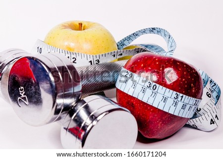 Fitness concept: Equiments and  Food on white background. Burning candle is for burning calories. 
